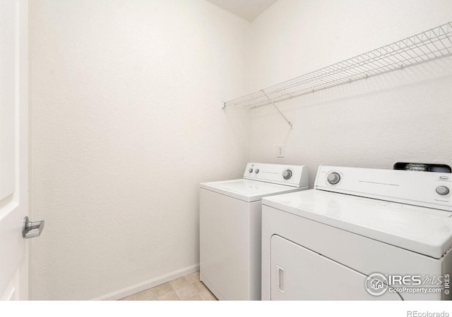 washroom featuring independent washer and dryer and light tile patterned floors