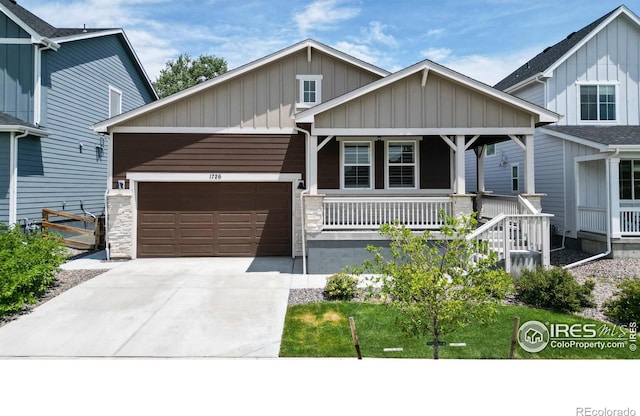 view of front of house featuring a porch and a garage