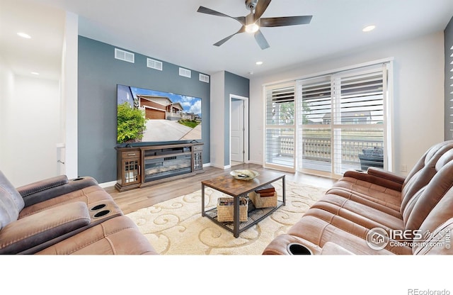 living room with ceiling fan and light hardwood / wood-style floors