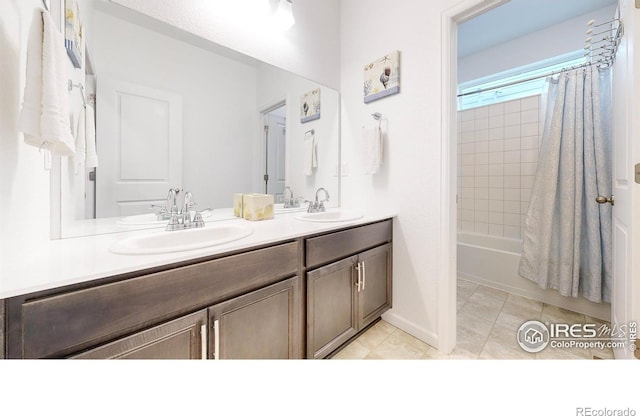 bathroom featuring tile patterned flooring, vanity, and shower / tub combo