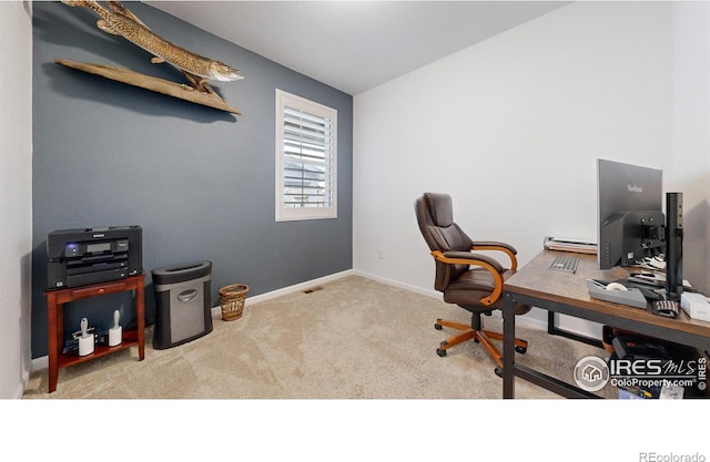 office with light colored carpet and lofted ceiling