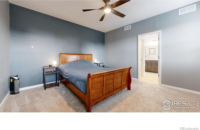 carpeted bedroom with ceiling fan and ensuite bath