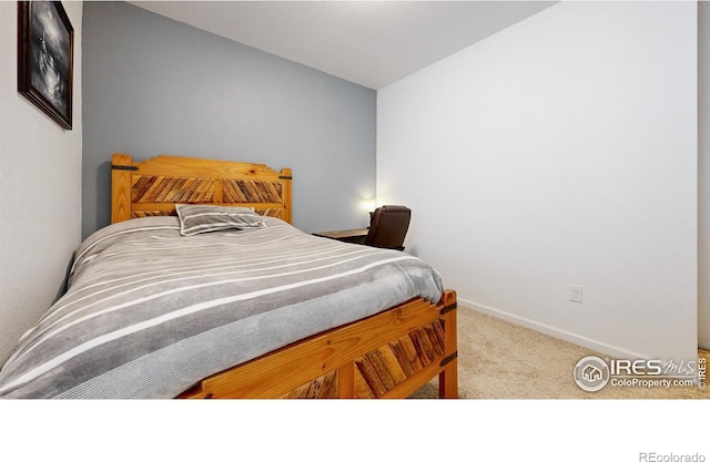 bedroom with carpet floors and lofted ceiling