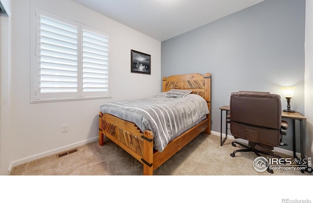 bedroom featuring light carpet and vaulted ceiling