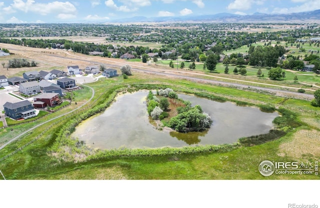 birds eye view of property featuring a water and mountain view