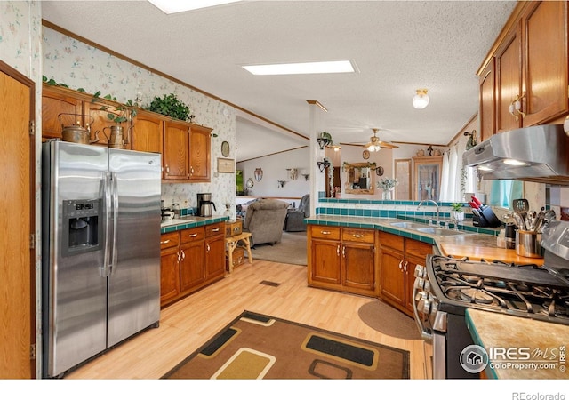 kitchen with sink, ceiling fan, light hardwood / wood-style floors, crown molding, and appliances with stainless steel finishes