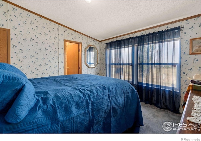 carpeted bedroom with a textured ceiling, crown molding, and multiple windows