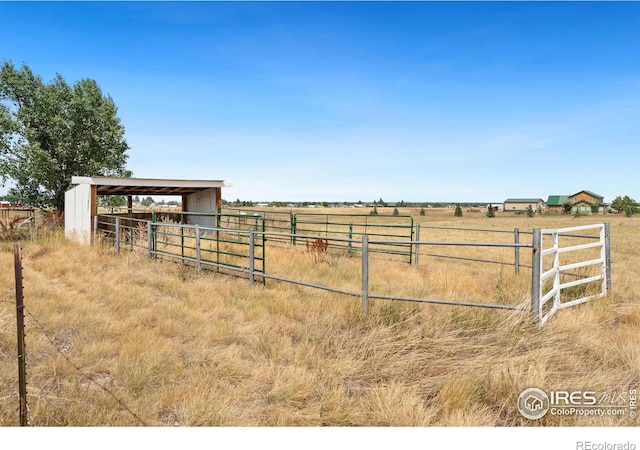 view of yard featuring an outbuilding and a rural view