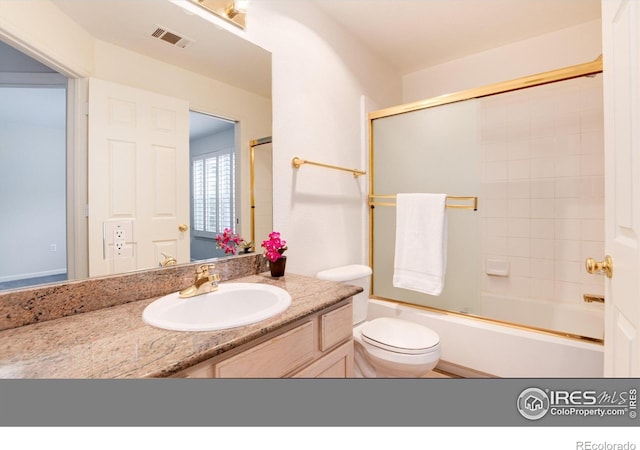 full bathroom with toilet, vanity, and combined bath / shower with glass door