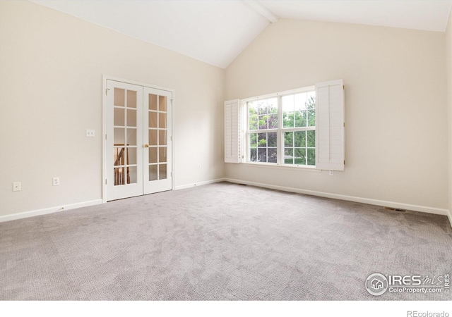 spare room with carpet flooring, french doors, and high vaulted ceiling