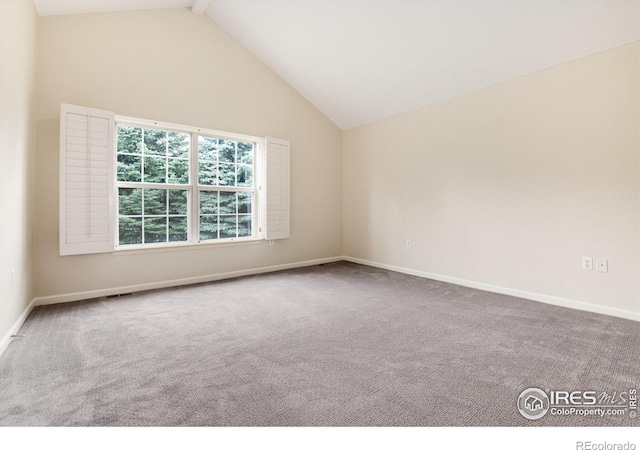 empty room featuring carpet flooring, beamed ceiling, and high vaulted ceiling