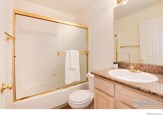 full bathroom with vanity, toilet, and enclosed tub / shower combo