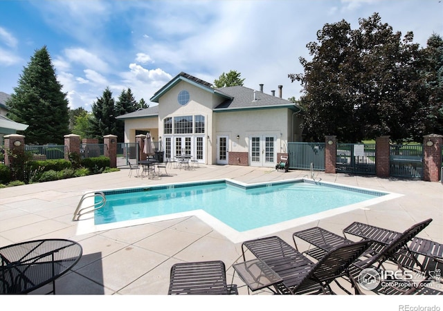 view of pool with a patio area and french doors