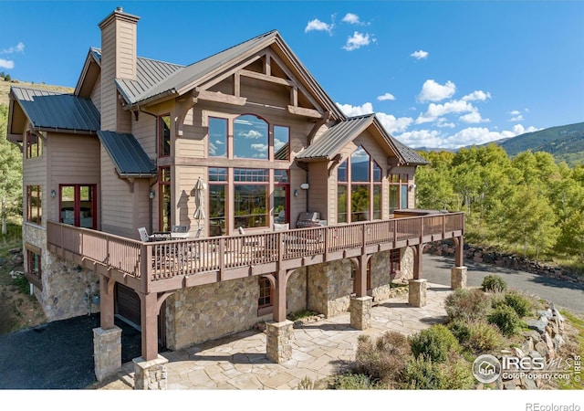 back of house featuring a patio and a deck