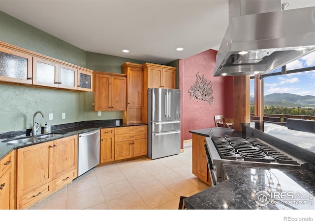 kitchen with stainless steel appliances, sink, a mountain view, dark stone counters, and island range hood