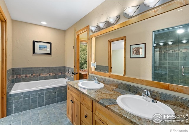 bathroom with tile patterned flooring, plus walk in shower, and vanity