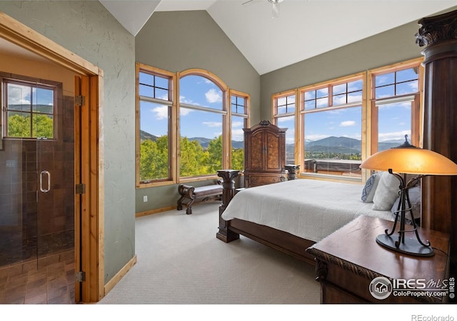 carpeted bedroom featuring ceiling fan, vaulted ceiling, and a mountain view