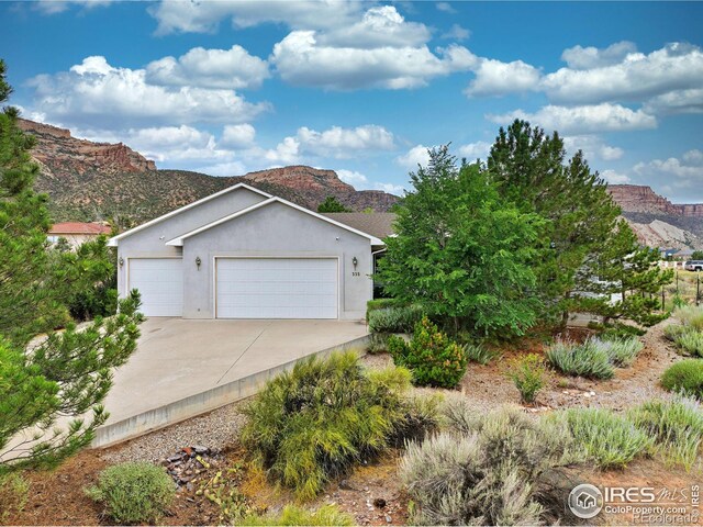 view of front of home with a mountain view and a garage