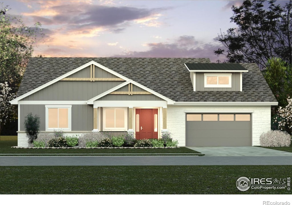 view of front of home with a garage and a lawn