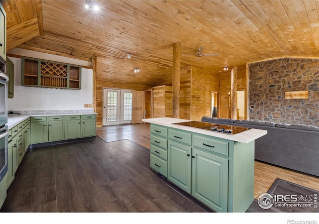 kitchen with lofted ceiling, wooden walls, dark wood-type flooring, green cabinets, and wooden ceiling