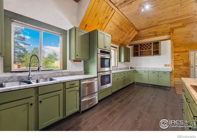 kitchen featuring appliances with stainless steel finishes, vaulted ceiling, wood ceiling, green cabinets, and dark wood-type flooring