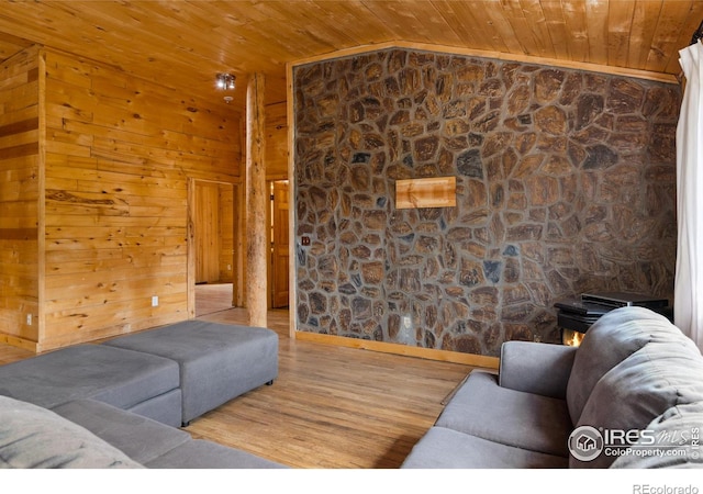 living room featuring wooden walls, lofted ceiling, light hardwood / wood-style floors, and wood ceiling