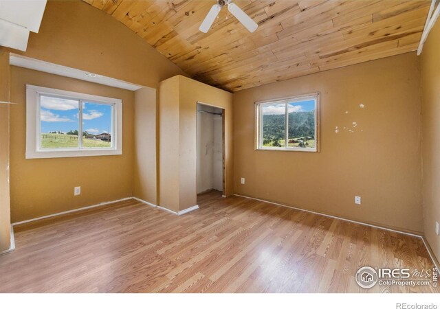 unfurnished bedroom with multiple windows, wood ceiling, light hardwood / wood-style flooring, and ceiling fan