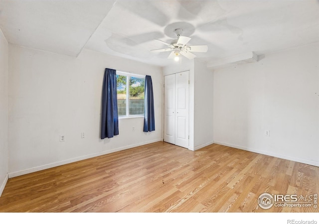 empty room featuring ceiling fan and light wood-type flooring