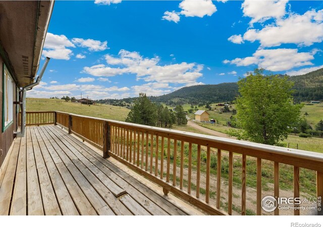 wooden deck with a mountain view