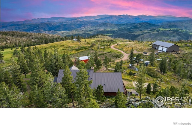 aerial view at dusk featuring a mountain view