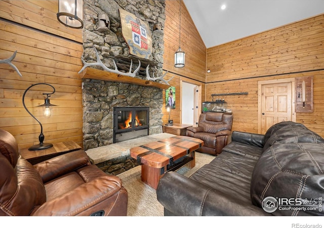 living room featuring a stone fireplace, high vaulted ceiling, and wooden walls