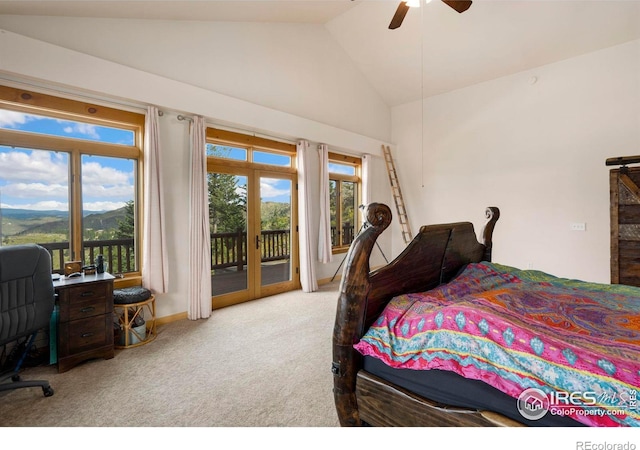 carpeted bedroom featuring multiple windows, lofted ceiling, access to outside, and ceiling fan