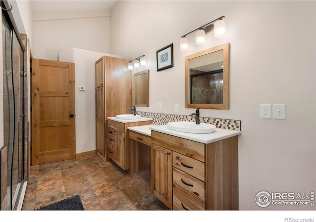 bathroom featuring vanity and decorative backsplash