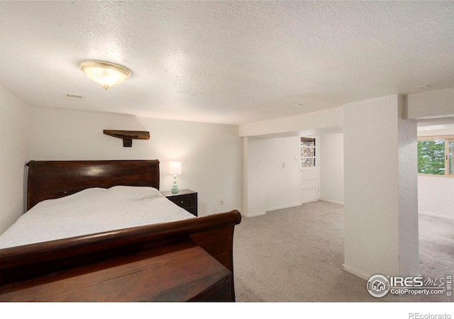 carpeted bedroom with a textured ceiling