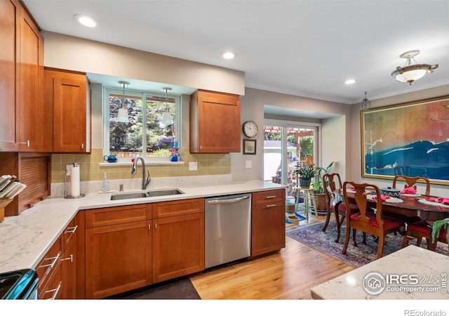 kitchen with light wood-type flooring, sink, decorative backsplash, and stainless steel appliances