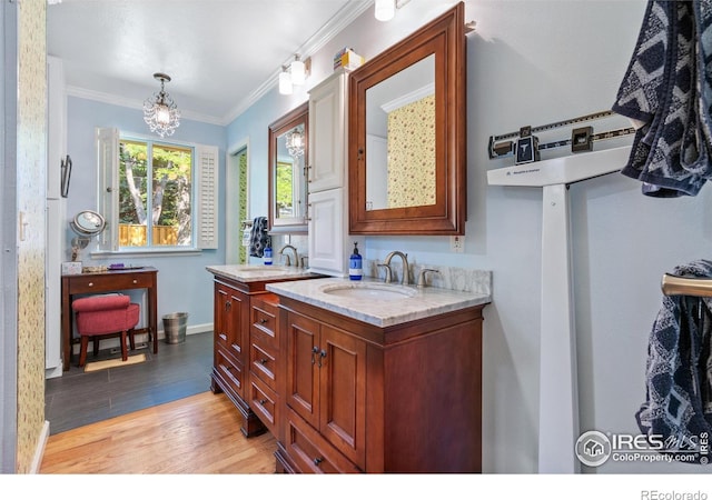 bathroom with vanity, ornamental molding, and hardwood / wood-style flooring