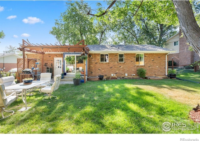 rear view of house with a pergola and a lawn