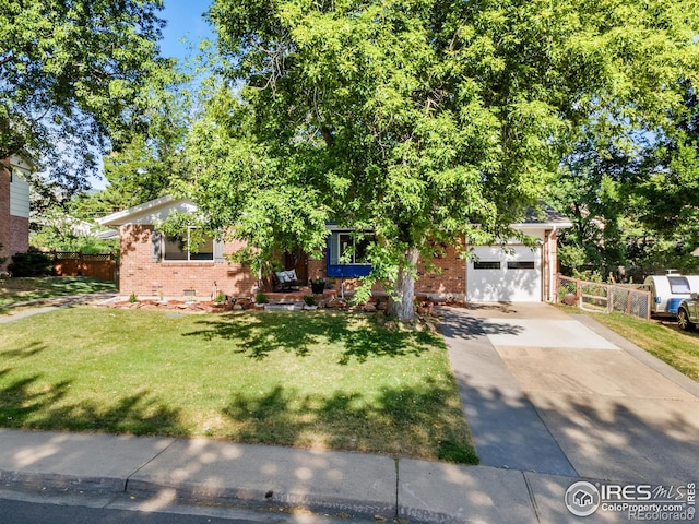 view of property hidden behind natural elements with a front yard and a garage