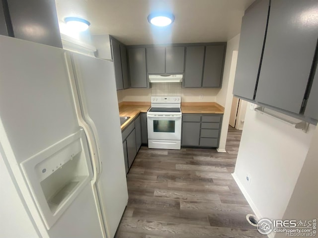 kitchen with dark wood-type flooring, white appliances, butcher block counters, and gray cabinets