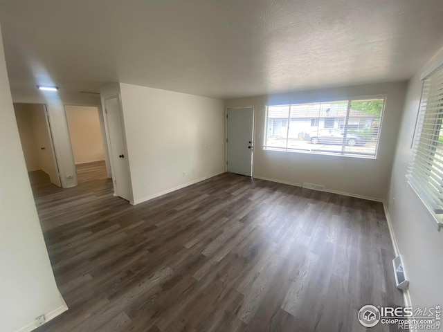 spare room with dark hardwood / wood-style flooring