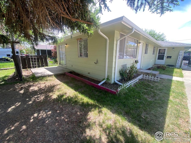 view of home's exterior featuring a yard and a patio area