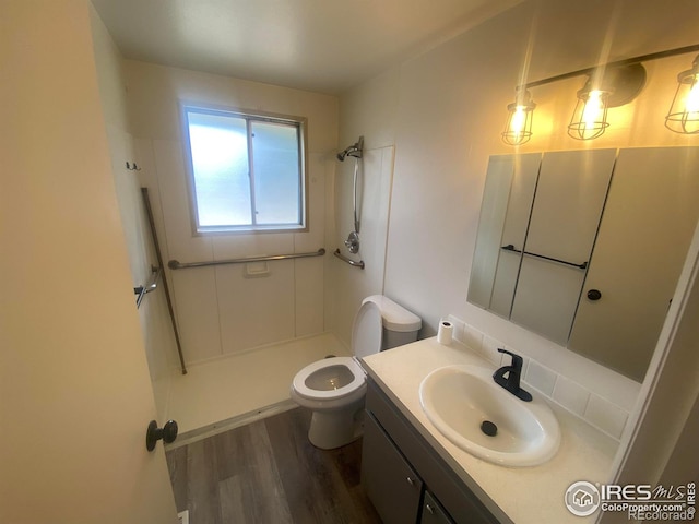 bathroom featuring hardwood / wood-style flooring, vanity, toilet, and walk in shower