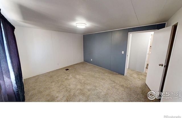 spare room with light colored carpet