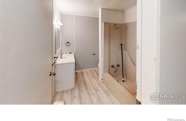 full bathroom featuring bathing tub / shower combination, vanity, toilet, and hardwood / wood-style floors