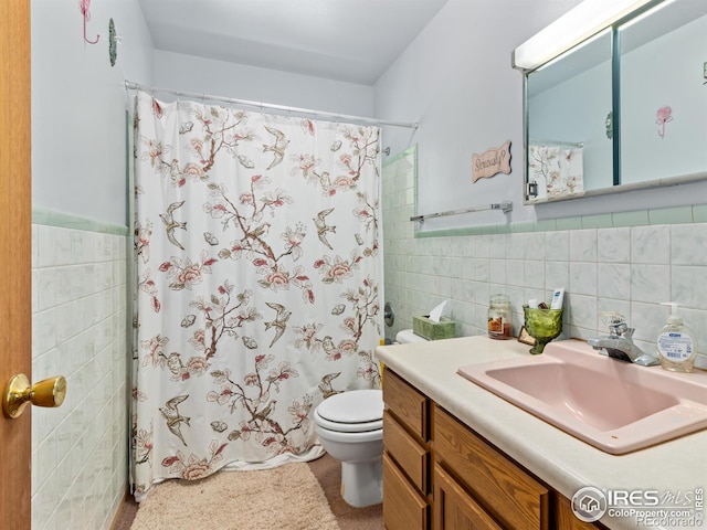 full bathroom featuring vanity, tile walls, toilet, and tasteful backsplash