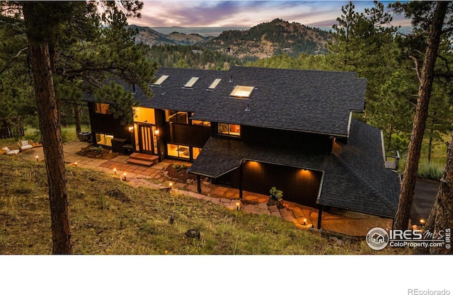 view of front of home with a patio area and a mountain view