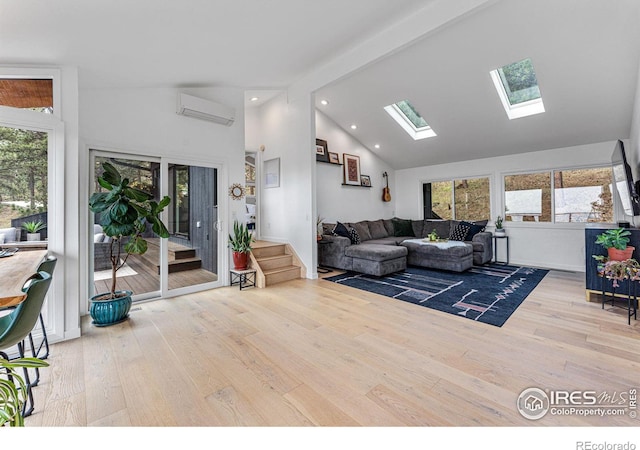 living room featuring beamed ceiling, a wall mounted AC, a wealth of natural light, and wood-type flooring