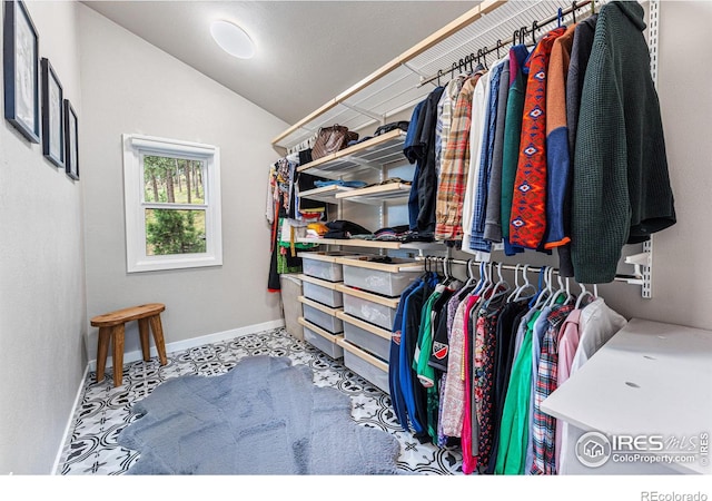 walk in closet with vaulted ceiling