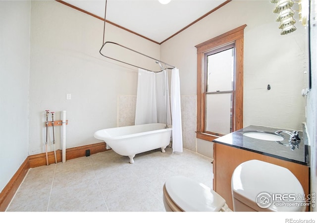 bathroom with tile patterned floors, crown molding, vanity, and toilet