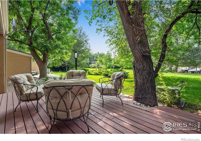 wooden terrace with a lawn